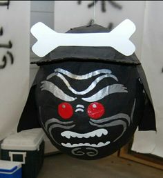 a black mask with red eyes and white bones on it