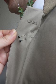 a man wearing a suit and tie with a boutonniere on his lapel