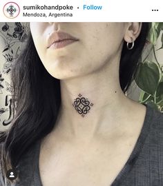 a woman with a small tattoo on her neck