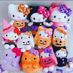 hello kitty stuffed animals are in a box with halloween decorations on the top and bottom