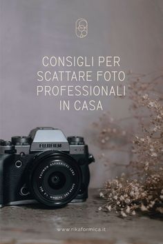 a camera sitting on top of a table next to some dried flowers and the words servizi fotografico di branding per artigani