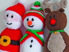 three knitted snowman and two reindeer dolls