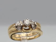 an engagement ring with two baguets on the side and a diamond in the middle