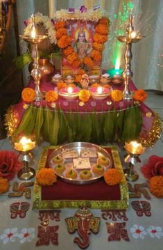 a decorated table with candles, plates and decorations