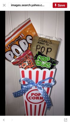 a popcorn box filled with assorted candy and candies on top of a door