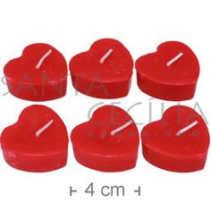 six red heart shaped candles are arranged in the shape of hearts, with one candle on top