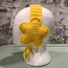 a yellow crocheted hat with a star on it