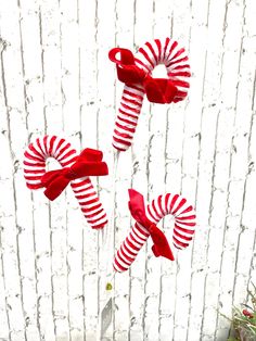 three red and white pinwheels on top of each other