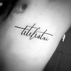 a woman's upper arm with the word tattoo on her left side ribcage