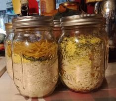 two jars filled with food sitting on top of a counter