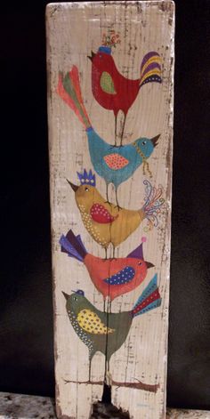 a wooden block with birds painted on it