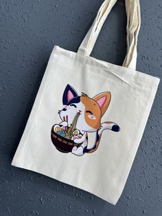 Ramen Calico Kitty Canvas Tote Bag Chibi/Funko Style Demon Sister Cream Color High Quality Tote  Product Description: -Individually DTF Pressed  -Durable /High Quality Tote Bag  -Product size :12.2*14.2 inches (31*36cm) -Cream Colored Great for grocery shopping , outdoor events, beach bag or trendy collectable gift. These reusable bags are made of polyester material, environmentally friendly and non-toxic, easy to fold and put away when not in use, and can be reused to avoid the pollution caused by using disposable paper and plastic bags. **Disclaimer: All sales are final due to the nature of the item. All items are uniquely made/placed by hand , minor defects may occur.  Once the item(s) ships, I have no control over the time it arrives to you.  Tracking information is provided as soon as Kawaii Beige Rectangular Shoulder Bag, White Cat Design Pouch Bag, Beige Rectangular Bag With Cat Design, Kawaii Tote Bag With Cat Design, Kawaii Cat Design Tote Bag, Cute Rectangular Beige Canvas Bag, White Cat Design Bag As A Gift, White Cat Design Bag As Gift, White Bag With Cat Design For Gift