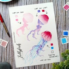 a watercolor drawing of jellyfish on white paper next to some paint swatches