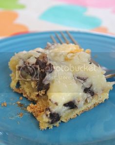 a blue plate with a piece of cake on it and a fork in the middle