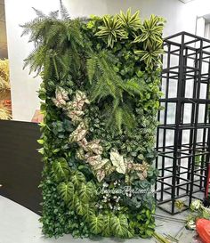 a green wall in an office building with plants growing on it and other greenery