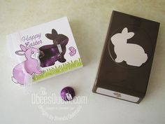 an easter card and chocolate egg are sitting on the table next to it's packaging