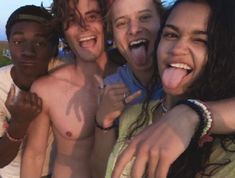 four people are taking a selfie with their tongue out and one person is sticking his tongue out