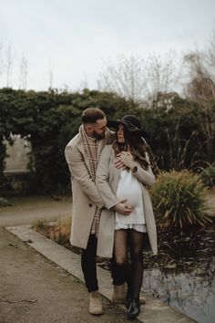 a pregnant couple standing next to each other