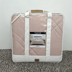 a piece of luggage sitting on top of a carpeted floor next to a wall