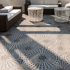 an outdoor seating area with wicker furniture