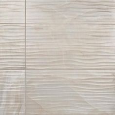 a white tile wall that has been made with wood grains and is very light brown