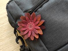 a flower is placed on top of a piece of fabric in a backpack or bag