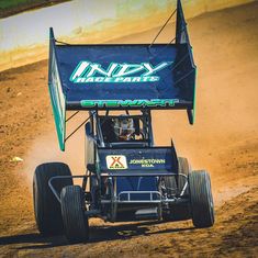 a man driving a buggy on top of dirt