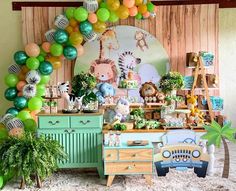 an animal themed birthday party with balloons and decorations