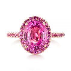 103630 Barbie inspired engagement ring   14k Rose Gold Ring   45 Pink Sapphires - .44 ctw   Joseph Jewelry. This gorgeous engagement ring features an oval pink sapphire prong set at the top, accented by a halo of split prong set pink sapphires, and additional pink sapphires running down the shoulders of the rose gold shank. It was created as part of a custom wedding set for a client from Seattle, WA, who came to us with a good idea of the kind of ring she wanted. Design Your Own Engagement Ring Pink Safire Engagement Rings, Sapphire Halo Engagement Ring, Sapphire Engagement Ring Halo, Pink Sapphire Engagement Ring, Oval Sapphire Ring, Joseph Jewelry, Pink Engagement Ring, Pink Sapphire Ring Engagement, Pink Sapphire Ring