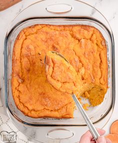 a person spoons into a casserole dish with sweet potatoes in the background