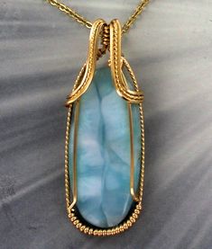 THE BEAUTY OF LARIMAR The stone weighs 50 carats Amazing 40MM LARIMAR gemstone----- set in handcrafted 14KT ROLLED GOLD ---- a custom design. LARIMAR gemstone with high detail which cannot be seen in the photograph. The pendant -- Intricate detail that you can see and notice MEASURES 2 inches long Very delicate and intricate in appearance and will get you noticed! One of a kind handcrafted piece of jewelry that anyone will look good in The pendant is absolutely amazing something that you will be Sculpted Jewelry, Wire Wrapped Stone Jewelry, Wire Wrap Jewelry Designs, Wrapping Jewelry, Necklace Ideas, Saint Joseph, Wire Wrapping Stones, Wrap Jewelry, Wire Work Jewelry