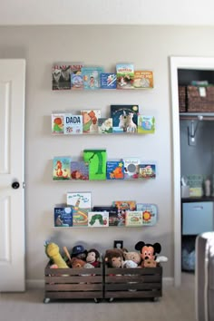 there are many books on the wall above the toy bins in this child's playroom