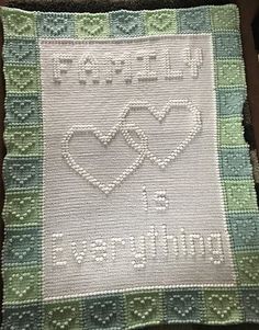 a cross stitch afghan with two hearts and the words, i love my daughter on it