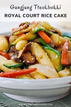 a white bowl filled with pasta and vegetables