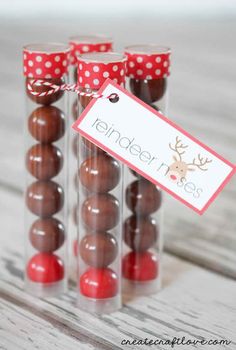 chocolate covered candies in clear glass containers with red polka dot ribbon and reindeer tags