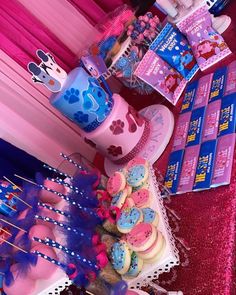 there is a cake and cupcakes on display at the table with other items