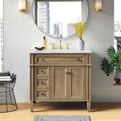 a bathroom vanity with a round mirror above it and a rug on the floor next to it