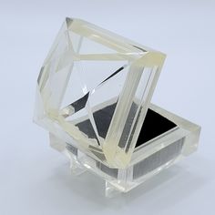 a clear diamond shaped object sitting on top of a table