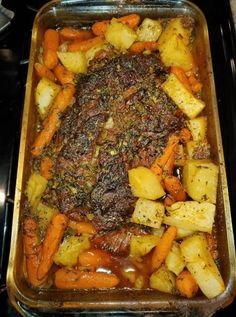 a casserole dish with carrots, potatoes and meat