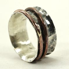 Oooh! two is better than one right? This spinner Ring is made from sterling silver and copper. The main ring is solid sterling silver and the two spinner rings are copper. The ring has a hammered and oxidized texture. The copper rings have an aged patina. the inside of the ring has a smooth matte finish This Ring can be made to order, please specify your size when checking out. Keep in mind that wider rings will feel about 1/4 - 1/2 size tighter. I can usually finish these in 2-3 days but please Unique Silver-colored Copper Ring, Vintage Silver-colored Copper Rings, Nickel Free Silver Copper Rings, Vintage Silver Copper Rings, Unique Silver Copper Ring, Two Is Better Than One, Wide Rings, Spinner Ring, Copper Rings