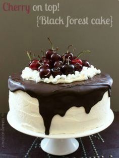 a cake with chocolate icing and cherries on top