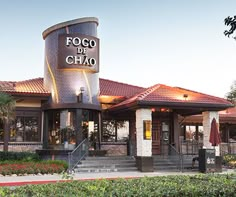 the exterior of a restaurant with an outside patio and stairs leading up to it's entrance