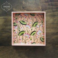 a pink box with flowers painted on it