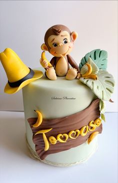 a cake with a monkey sitting on top of it