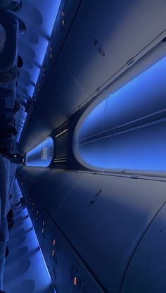 the inside of an airplane with blue lights