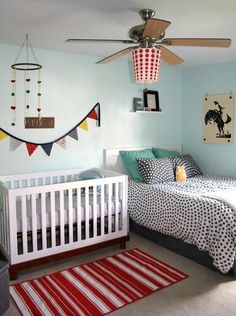 a baby's room with a crib, bed and rug