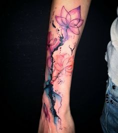 a woman's arm with flowers painted on it