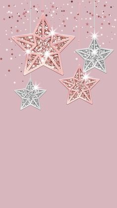 three pink and silver stars hanging from strings