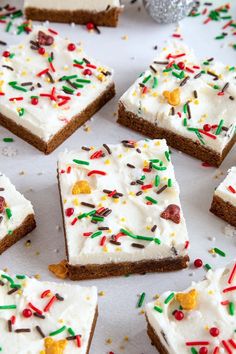 several pieces of cake with white frosting and sprinkles