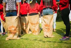 some people are standing in the grass with bags